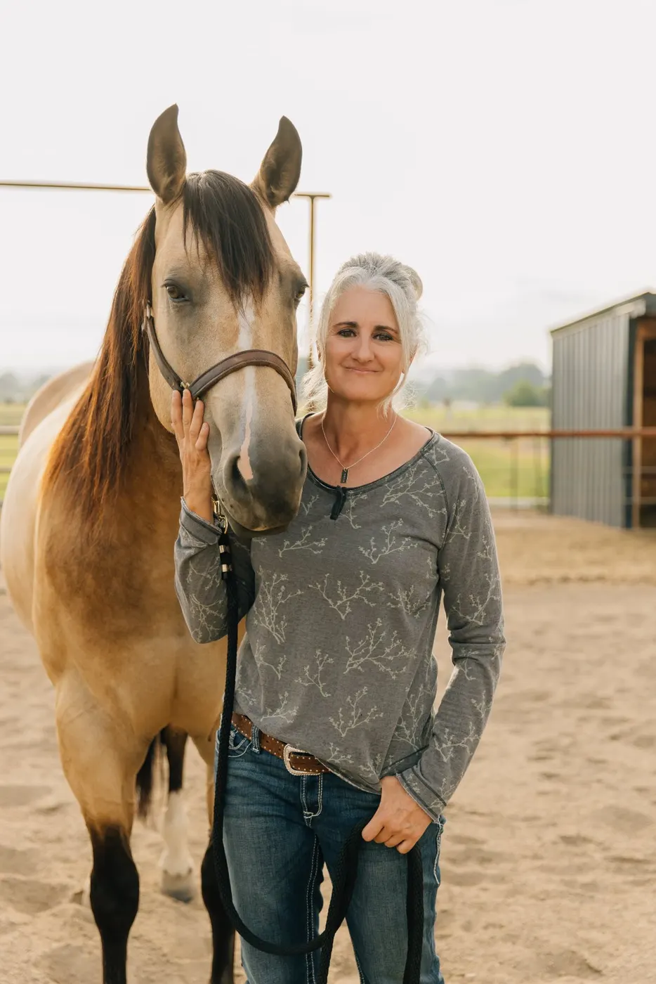 Kellie with her buckskin mare in the arena