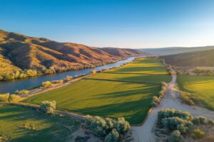 Aerial view of a working ranch along the Snake River in southwestern Idaho with green irrigated hay fields